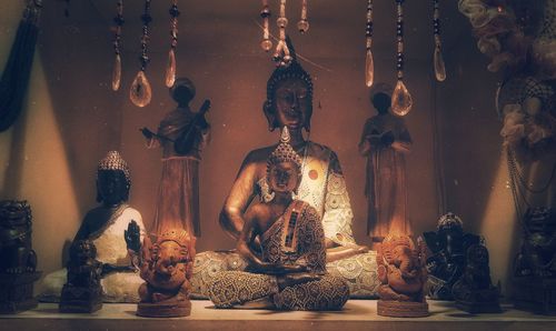 Statue of buddha against wall