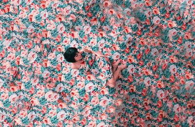 High angle view of woman with pink petals in background