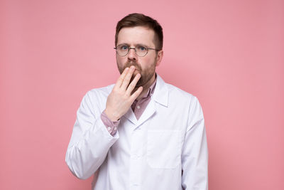 Portrait of man wearing mask against gray background