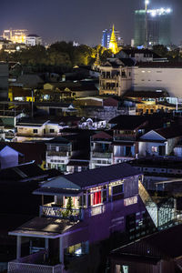 High angle view of illuminated buildings in city at night