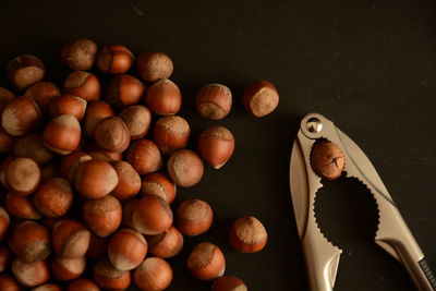 Directly above shot of hazelnut and nutcracker on table