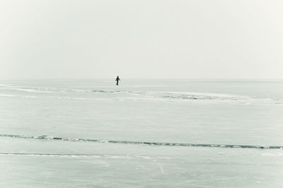 Man surfing in sea against sky