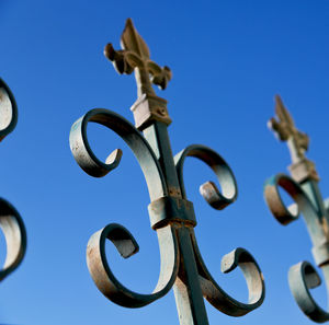 Low angle view of chain against blue sky