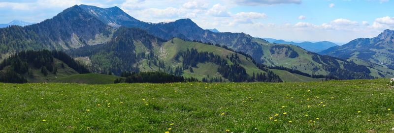 Scenic view of field and mountains against sky