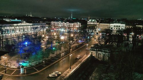 High angle view of illuminated street amidst buildings at night