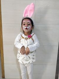 Portrait of cute girl standing on floor