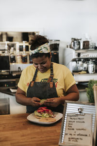 Woman holding ice cream in restaurant