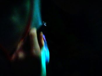 Close-up of woman hand in illuminated light