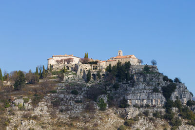 Low angle view of castle against clear blue sky