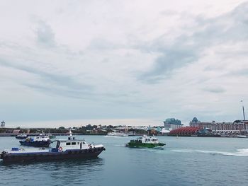 Boats in sea against sky