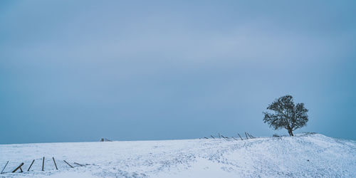 Scenic view of snow covered field against clear sky