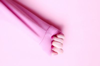 Low section of person against pink background