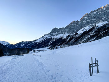 Scenic view of snow covered field against clear sky