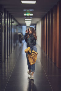 Full length of woman standing in corridor