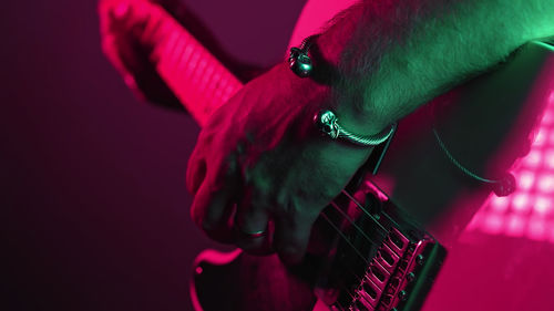 Cropped hand of man playing guitar