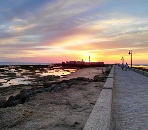 View of calm beach at sunset