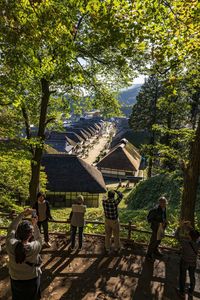 Rear view of people walking outside building