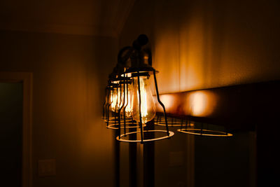 Close-up of illuminated lamp on wall at home