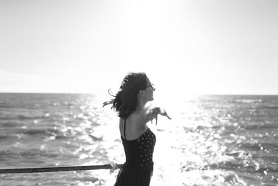 Young girl in dress enjoying a vacation near the summer sea of italy