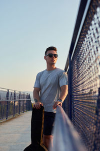 Young man wearing sunglasses against sky