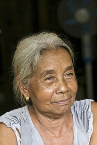 A close-up of a single indigenous woman with a serious demeanor