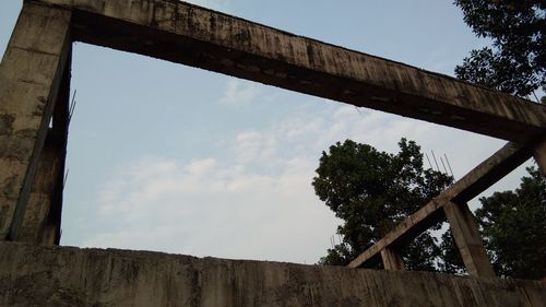 Low angle view of old bridge against sky