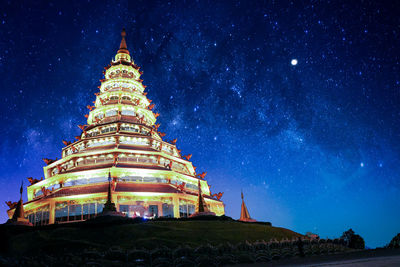Low angle view of illuminated building against sky at night