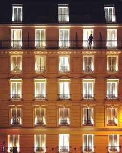 Reflection of building on glass window at night