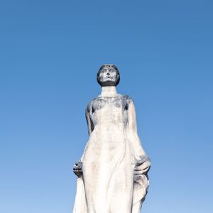 Low angle view of statue against blue sky