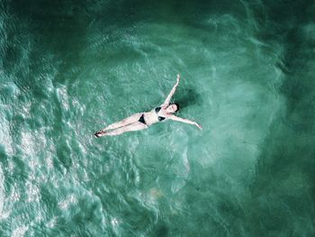 High angle view of woman swimming in pool