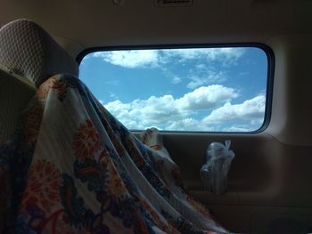 Panoramic shot of train window against sky