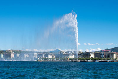 Panoramic view of sea and buildings against sky