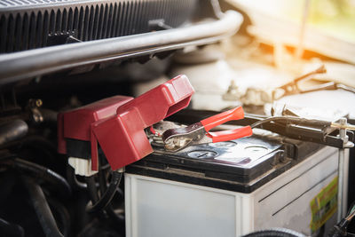 Close-up of jumper cable on car battery