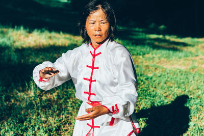 Mature woman practicing martial arts at park