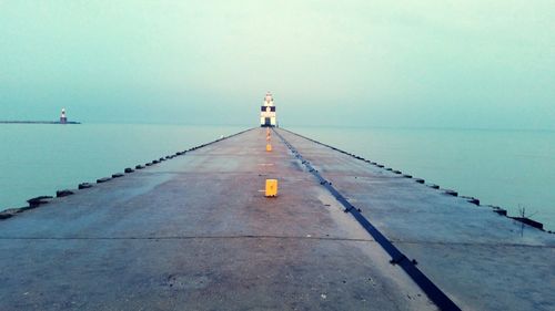 Empty road along calm blue sea