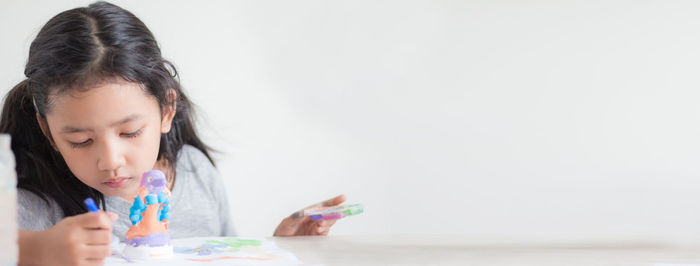 Girl playing with ball on table