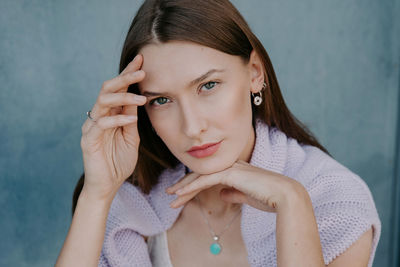 Portrait of a beautiful young woman holding camera