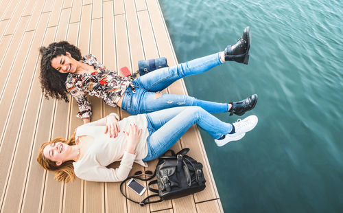 High angle view of woman sitting on deck chair