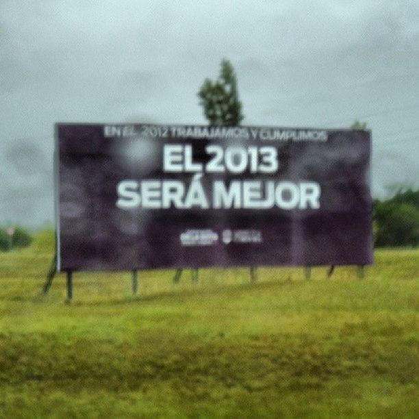 text, western script, communication, grass, field, information sign, sign, green color, capital letter, information, non-western script, guidance, sky, grassy, day, focus on foreground, number, no people, close-up, warning sign