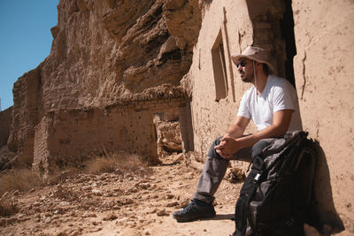 Side view of young man on rock