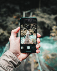 Close-up of person photographing with mobile phone