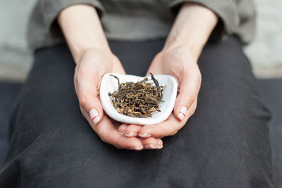 Midsection of woman holding marijuana