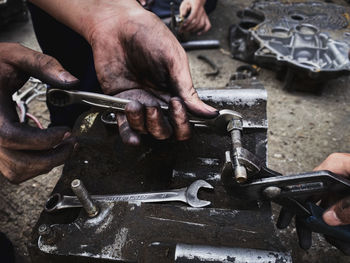 Cropped hand of man welding metal