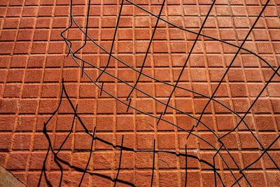 High angle view of metal grate on footpath