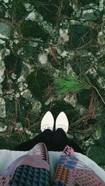 Low section of woman standing on ground