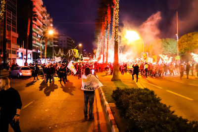 People on city street at night