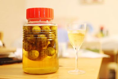 Close-up of food by drink glass in jar on table