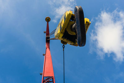 Low angle view of crane against blue sky