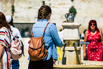 Rear view of people standing outdoors