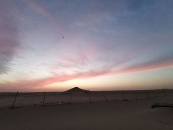 Scenic view of beach against sky during sunset